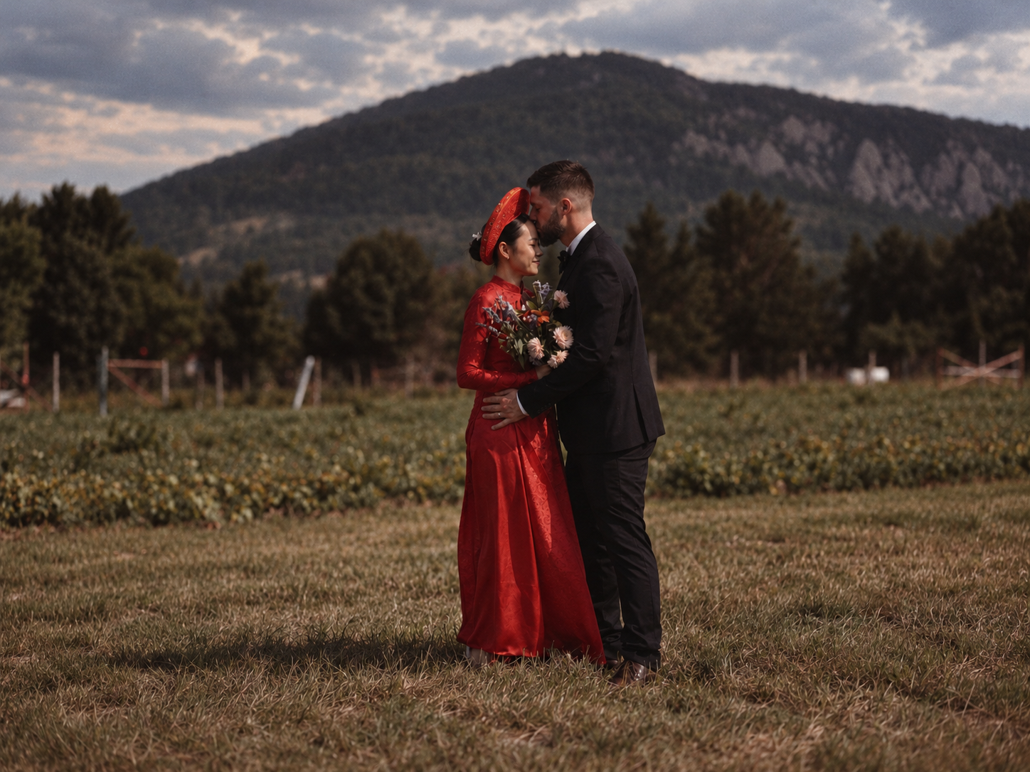 Thu and Simon with the mountains behind them in Rougemont, Quebec