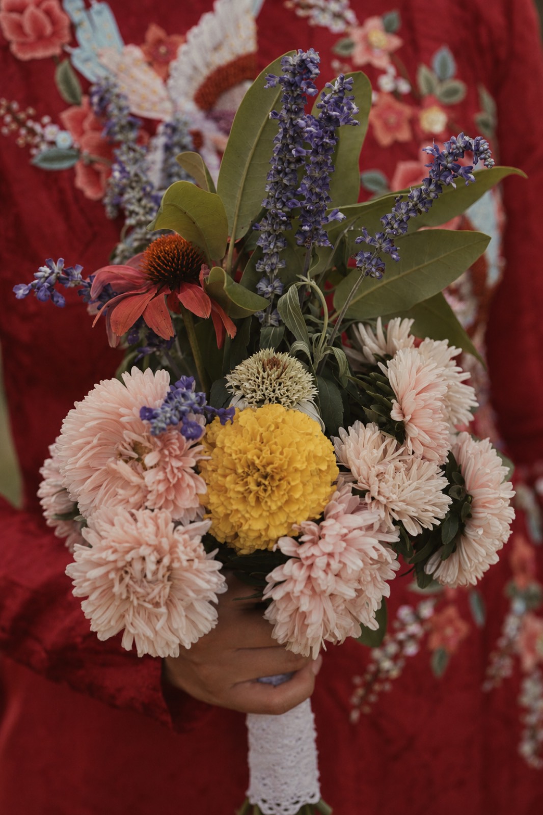 Thu's bouquet against embroidered red fabric in Rougemont, Quebec