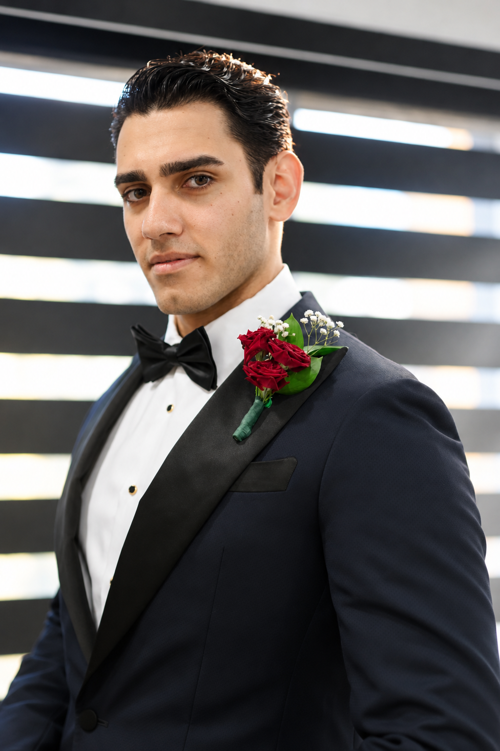 Pouya in his tuxedo with a red rose boutonniere