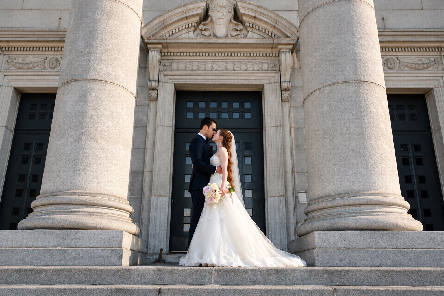 Jenna and Pouya beneath the classical stonework