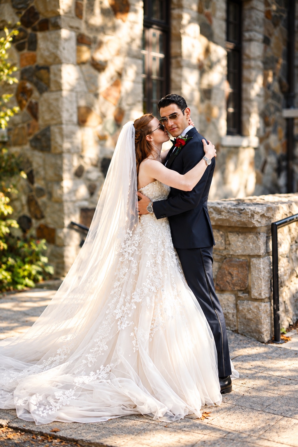 Jenna and Pouya embracing in the stone courtyard