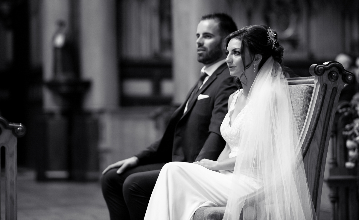 Kristine and Kenneth seated during their wedding ceremony