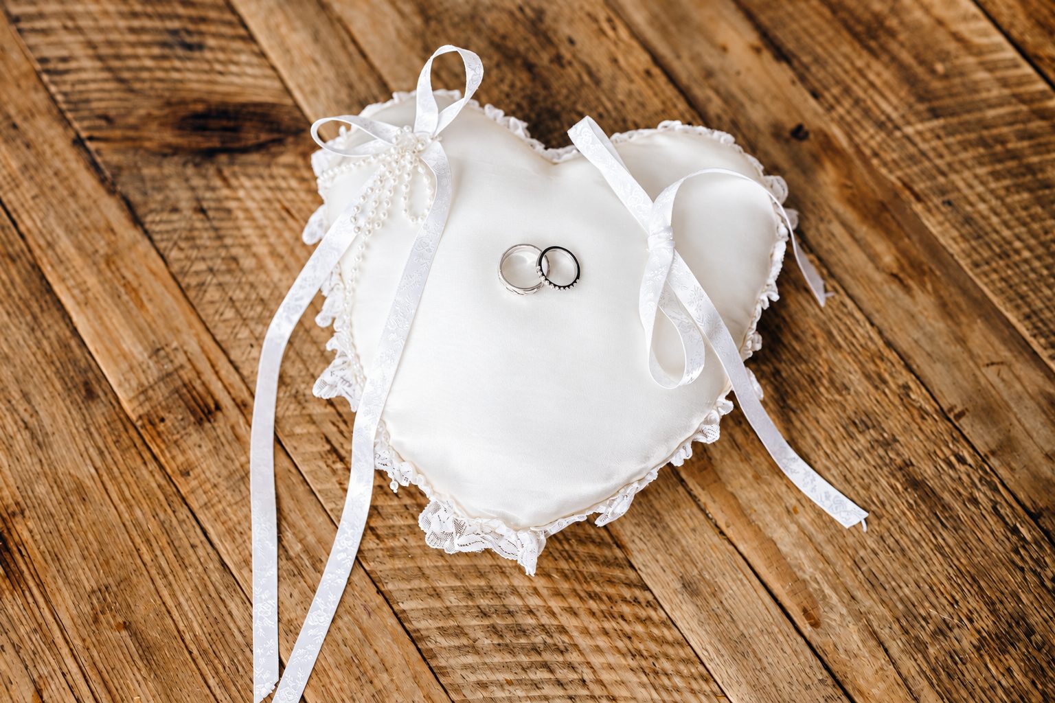 Wedding rings on a heart-shaped pillow