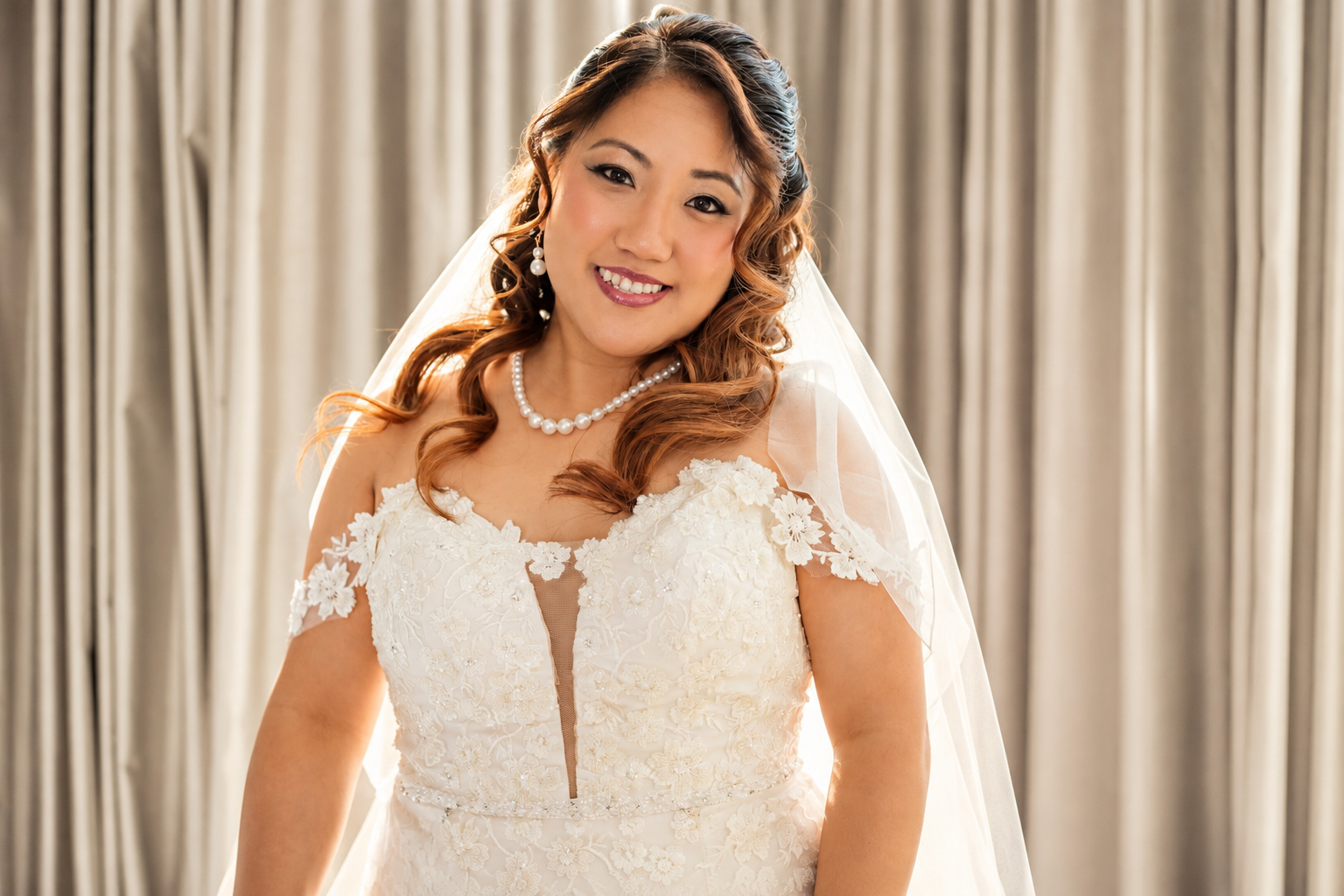 Mae in her lace gown and pearls