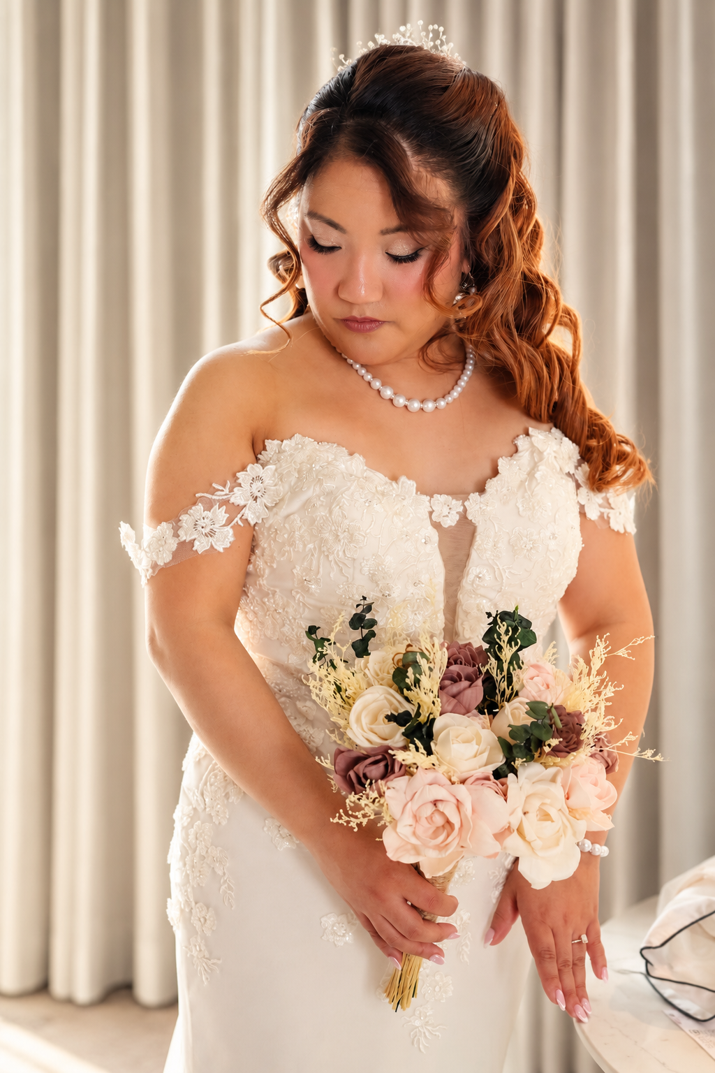 Mae looking down at her bouquet