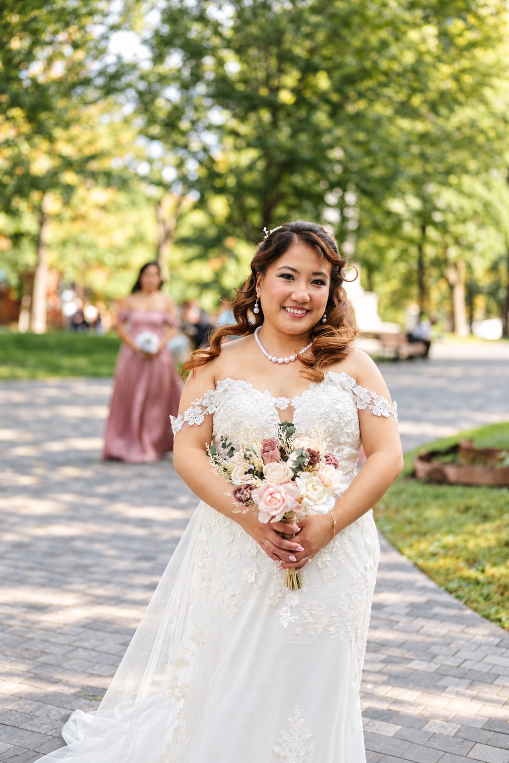 Mae smiling in the garden with her bouquet