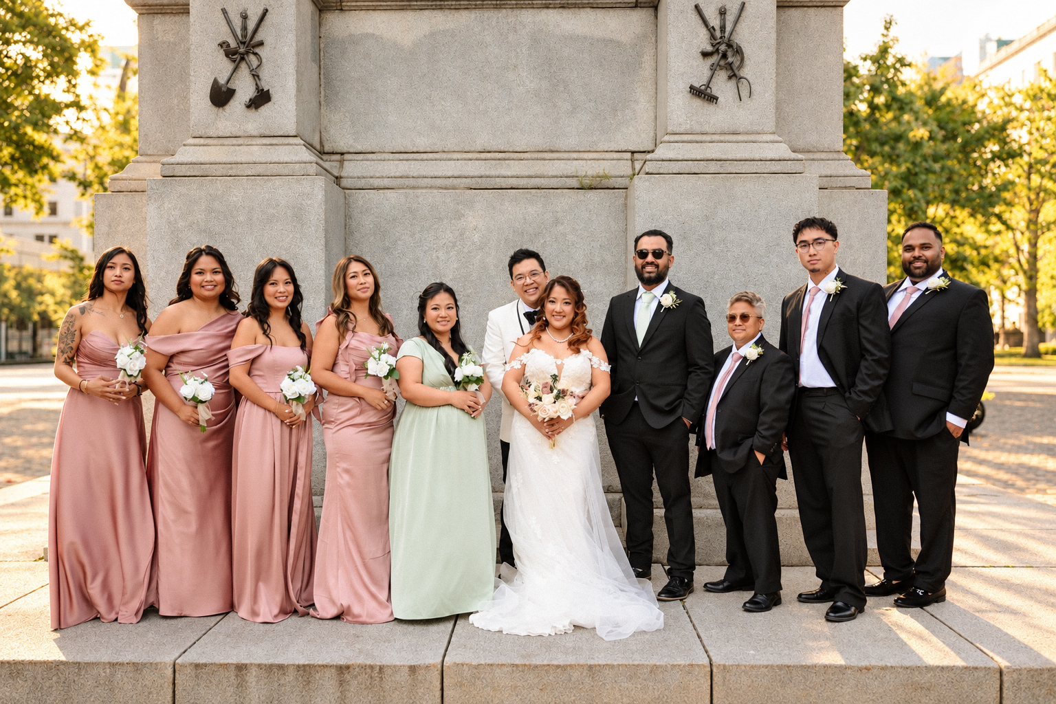 Mae and Daryl with their wedding party at the stone monument