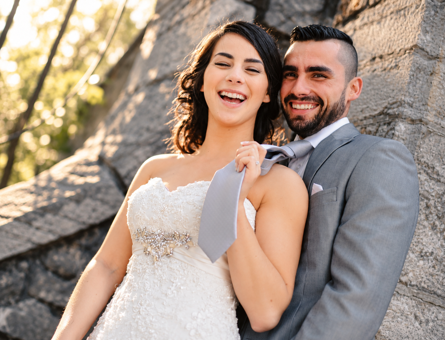 Sara holding Kevin's tie and laughing
