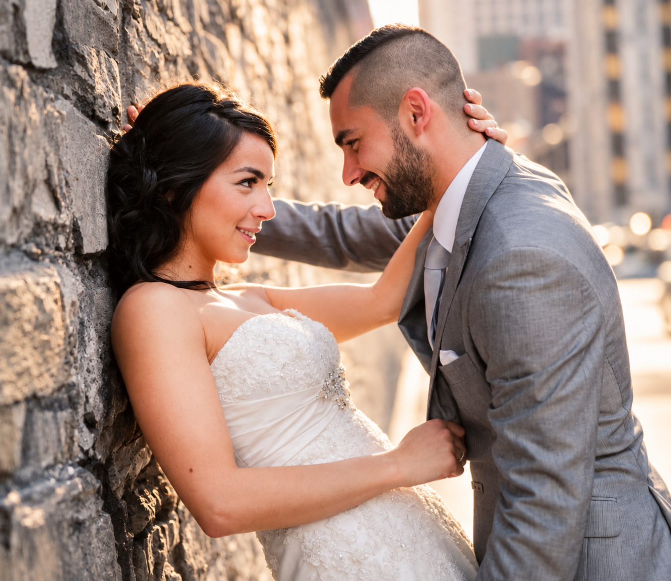 Sara and Kevin looking at each other by a stone wall