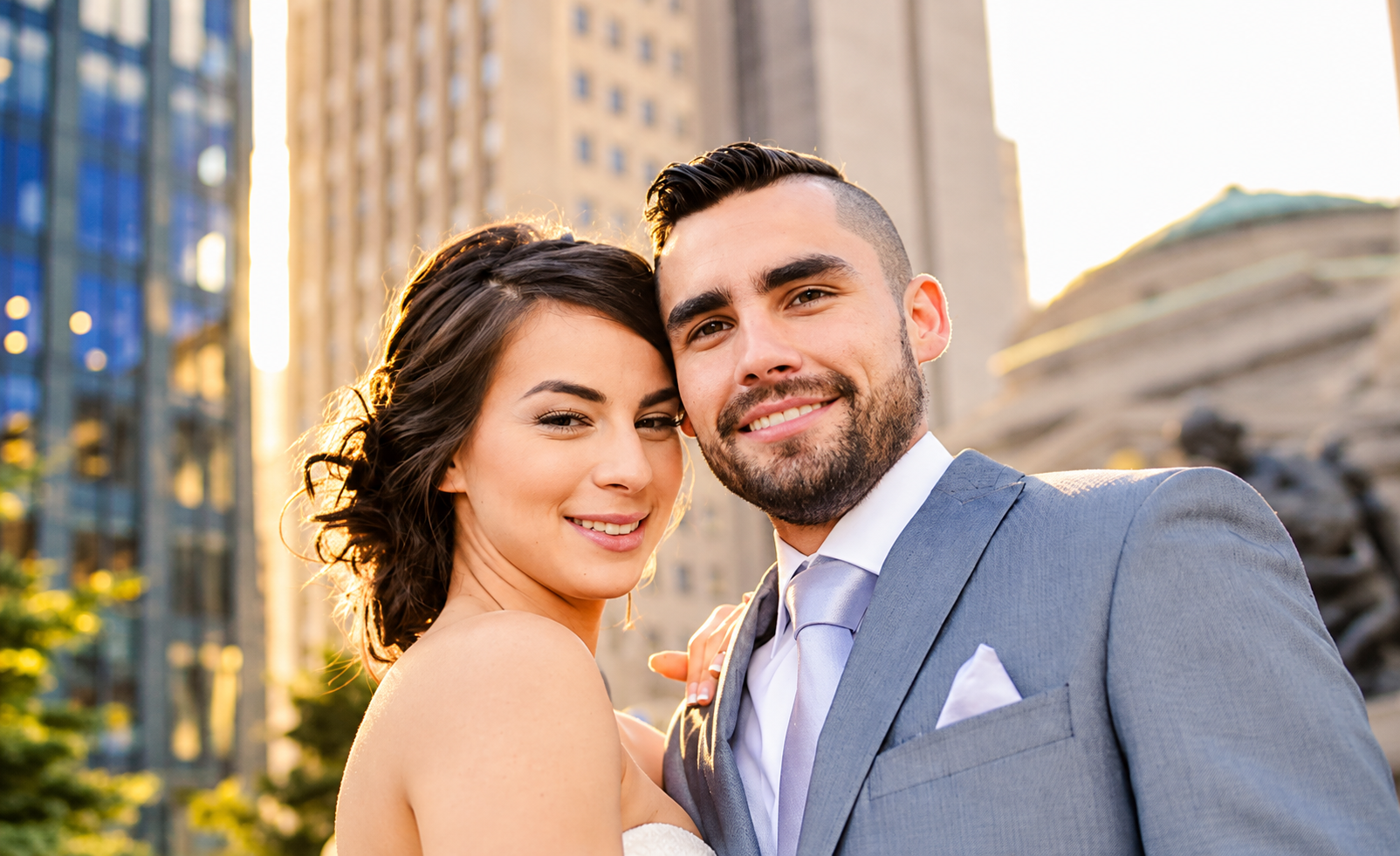 Sara and Kevin smiling in a city portrait